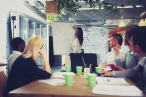 Businesswoman explaining graph to her colleagues